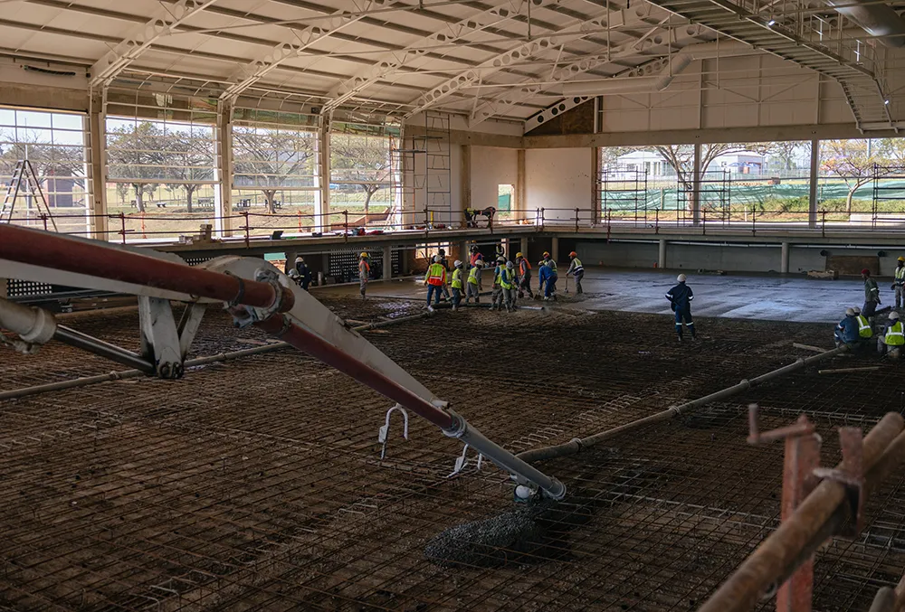 AquaPark foundation works underway, concrete slabs and reinforcing steel visible across the site.