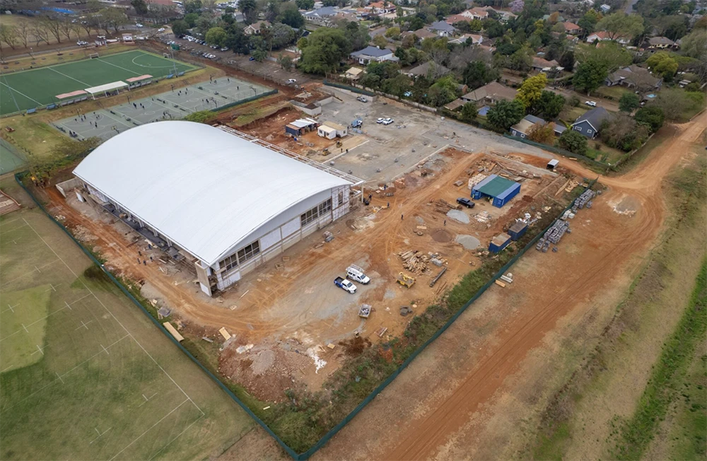 Wide shot of the AquaPark indoor pool hall with natural light filtering through upper windows.